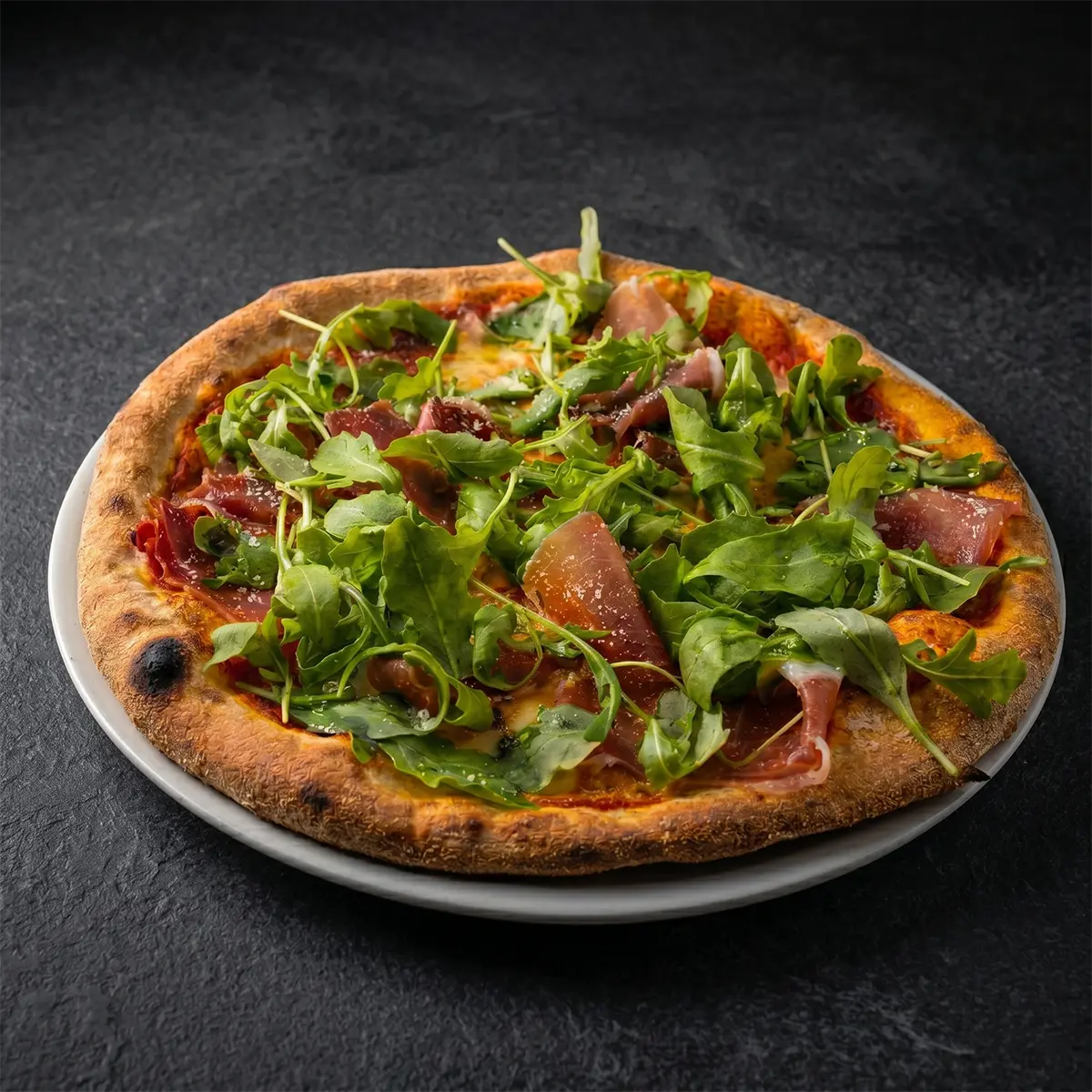 Pizza Olivia with Serrano ham, mozzarella and rocket